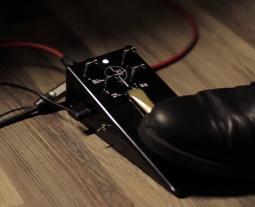 A sustain pedal being used by a guitar player
